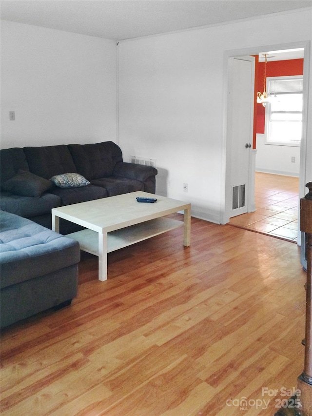 living area featuring visible vents and light wood-style floors