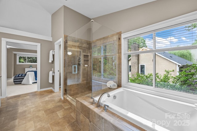 full bathroom featuring baseboards, a bath, connected bathroom, and a stall shower