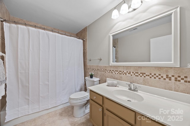 full bathroom featuring visible vents, tile walls, tile patterned flooring, vanity, and toilet