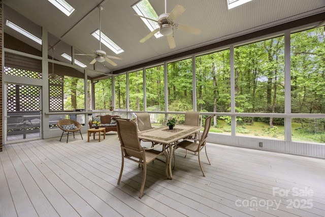sunroom / solarium with a skylight, ceiling fan, and outdoor dining space