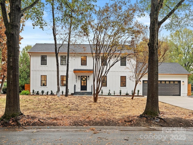 modern inspired farmhouse with concrete driveway, board and batten siding, an attached garage, and roof with shingles