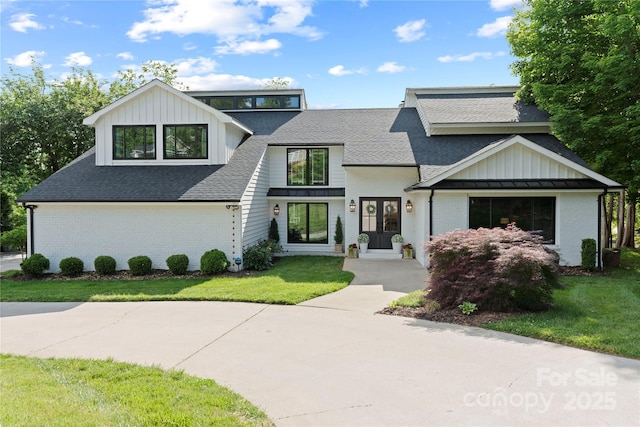 4039 5th St NW, Hickory, NC 28601 - modern farmhouse featuring french doors, roof with shingles, brick siding, a front lawn, and board and batten siding