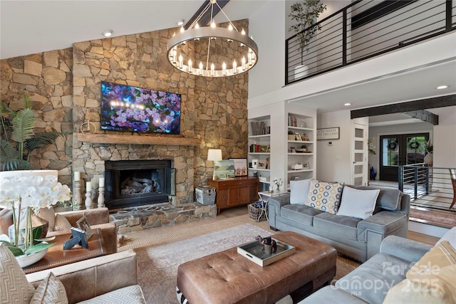 4039 5th St NW, Hickory, NC 28601 - living area with a chandelier, built in shelves, a towering ceiling, and a stone fireplace