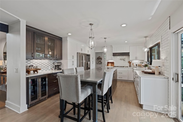 4039 5th St NW, Hickory, NC 28601 - dining space featuring beverage cooler, light wood-style flooring, bar area, and recessed lighting