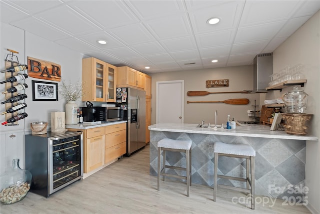 4039 5th St NW, Hickory, NC 28601 - kitchen featuring recessed lighting, light brown cabinets, appliances with stainless steel finishes, a peninsula, and wine cooler