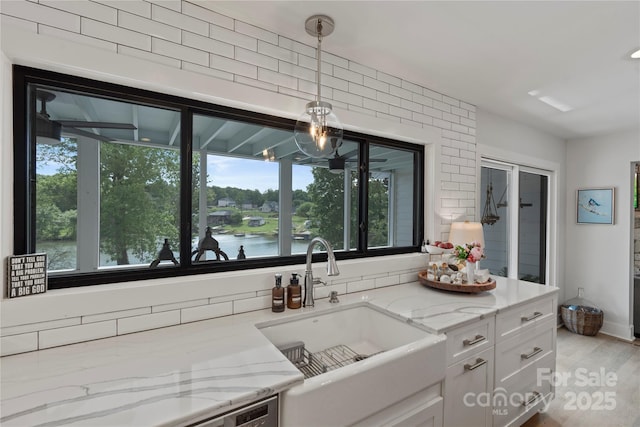 4039 5th St NW, Hickory, NC 28601 - kitchen with a sink, plenty of natural light, light stone counters, and white cabinetry