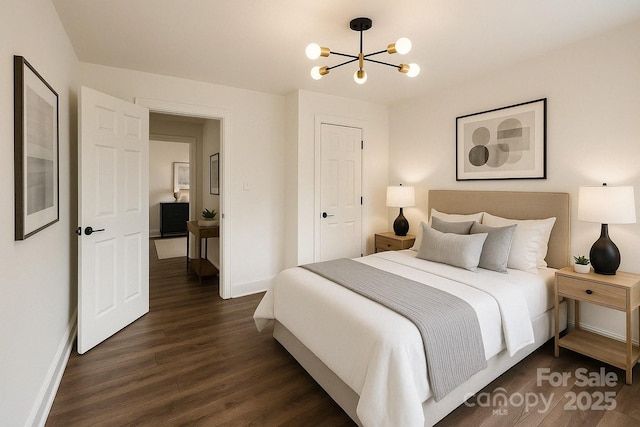bedroom with baseboards, an inviting chandelier, and dark wood finished floors