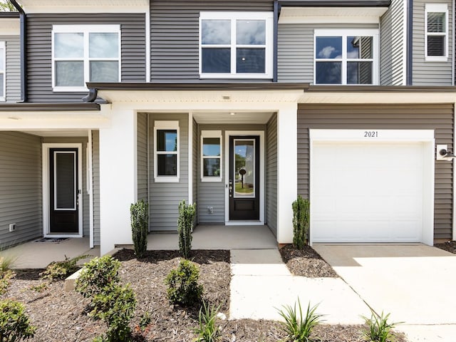 2021 Endeavor Run, Charlotte, NC 28269 - entrance to property featuring an attached garage, driveway, and covered porch