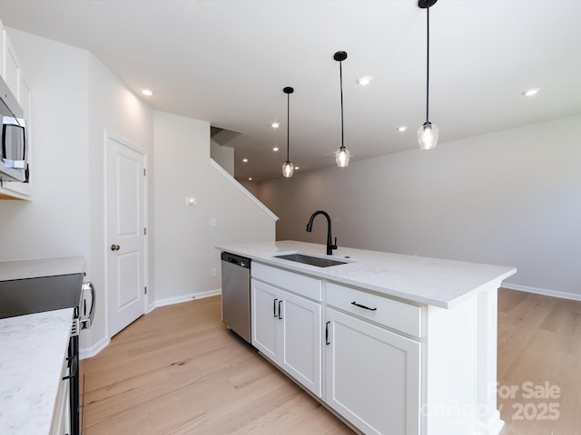 2021 Endeavor Run, Charlotte, NC 28269 - kitchen featuring a sink, stainless steel appliances, light wood-style floors, a center island with sink, and white cabinetry