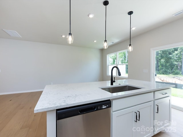 2021 Endeavor Run, Charlotte, NC 28269 - kitchen featuring stainless steel dishwasher, a sink, light wood-style floors, an island with sink, and hanging light fixtures