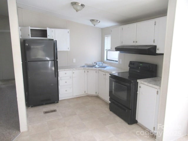 5180 Macedonia Church Rd, Vale, NC 28168 - kitchen with a sink, light countertops, under cabinet range hood, black appliances, and white cabinetry