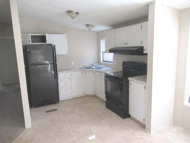 5180 Macedonia Church Rd, Vale, NC 28168 - kitchen with white cabinets, black appliances, under cabinet range hood, light countertops, and plenty of natural light