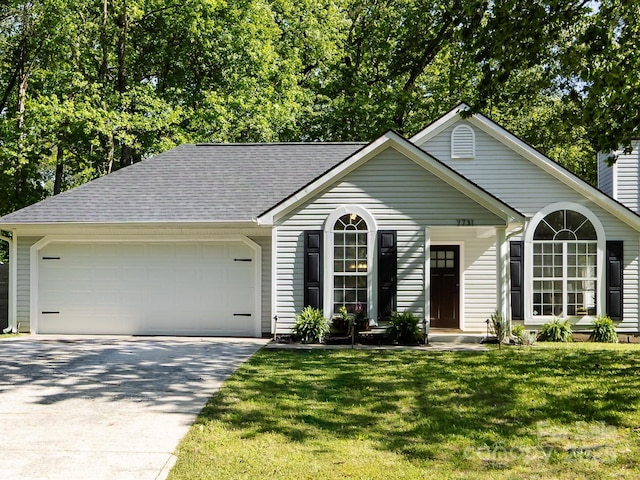 7731 Ivy Hollow Dr, Charlotte, NC 28227 - single story home with a shingled roof, concrete driveway, a front yard, and a garage
