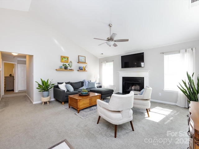 7731 Ivy Hollow Dr, Charlotte, NC 28227 - living area with a fireplace, vaulted ceiling, a ceiling fan, and light carpet