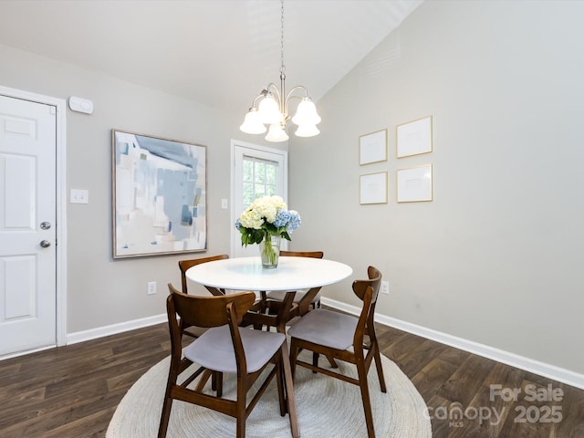 7731 Ivy Hollow Dr, Charlotte, NC 28227 - dining room featuring vaulted ceiling, baseboards, dark wood-style flooring, and an inviting chandelier