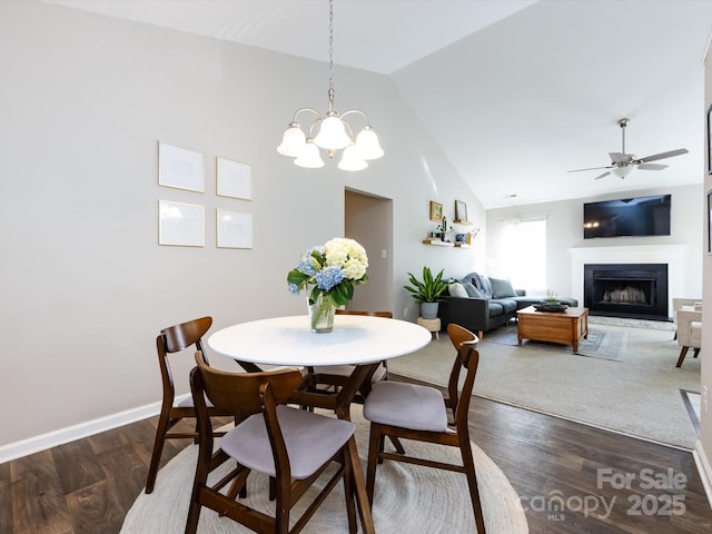 7731 Ivy Hollow Dr, Charlotte, NC 28227 - dining room with ceiling fan with notable chandelier, baseboards, a fireplace, and dark wood-style flooring