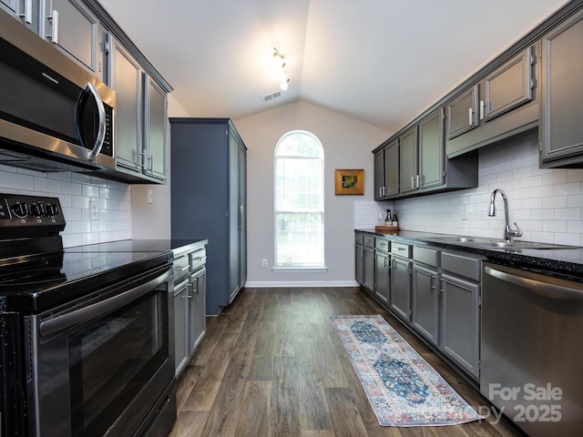 7731 Ivy Hollow Dr, Charlotte, NC 28227 - kitchen featuring lofted ceiling, stainless steel appliances, visible vents, and dark countertops