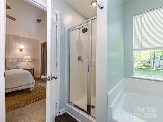 7731 Ivy Hollow Dr, Charlotte, NC 28227 - full bathroom featuring visible vents, a ceiling fan, ensuite bath, a garden tub, and a stall shower