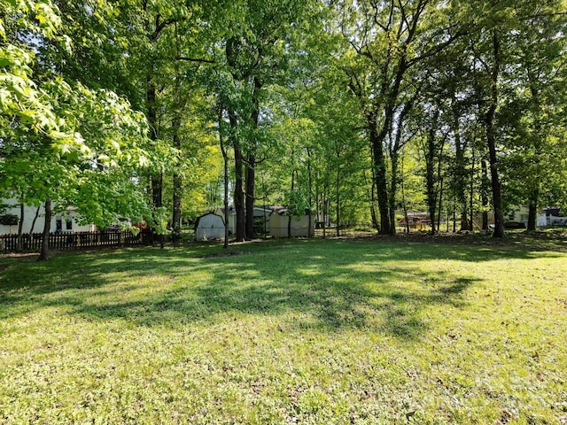 7731 Ivy Hollow Dr, Charlotte, NC 28227 - view of yard with fence, an outdoor structure, and a shed