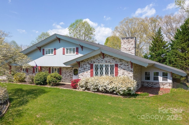 tri-level home with a front yard, brick siding, and a chimney