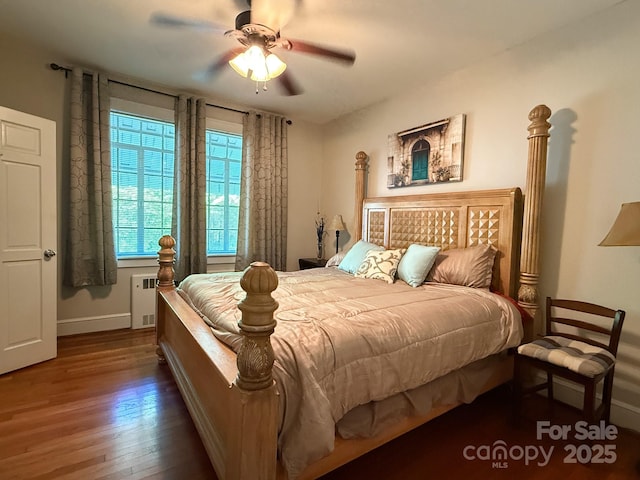 559 N Washington St, Rutherfordton, NC 28139 - bedroom with radiator, wood finished floors, baseboards, and ceiling fan