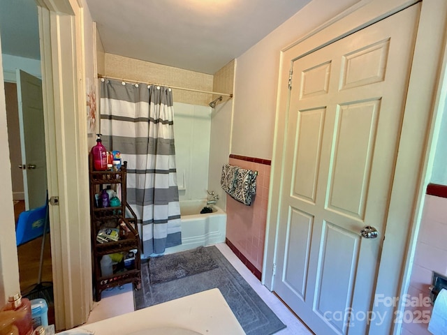 559 N Washington St, Rutherfordton, NC 28139 - bathroom featuring tile walls, wainscoting, and shower / tub combo with curtain