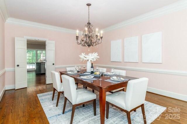1233 Weymouth Ln, Charlotte, NC 28270 - dining area featuring an inviting chandelier, ornamental molding, baseboards, and dark wood-style floors