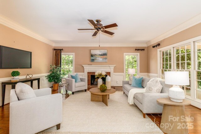 1233 Weymouth Ln, Charlotte, NC 28270 - living room with crown molding, ceiling fan, wainscoting, and a healthy amount of sunlight