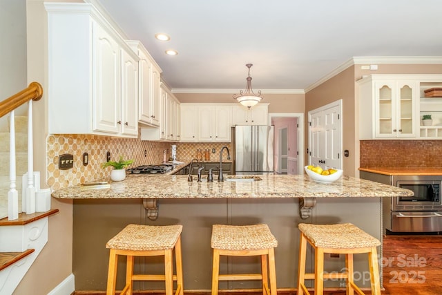 1233 Weymouth Ln, Charlotte, NC 28270 - kitchen with decorative backsplash, light stone countertops, a sink, a peninsula, and stainless steel appliances