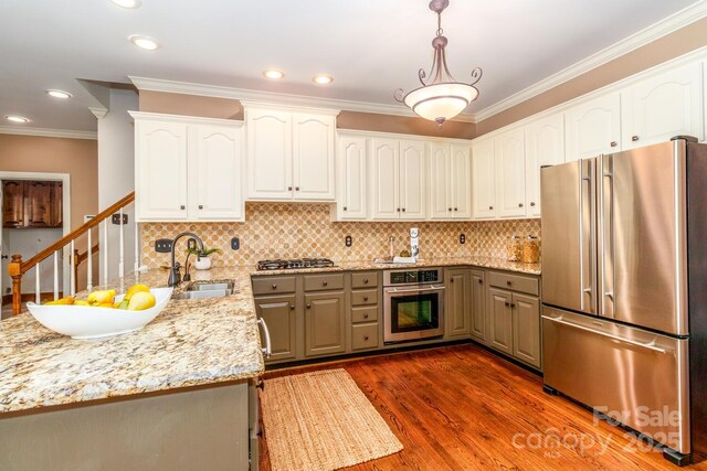 1233 Weymouth Ln, Charlotte, NC 28270 - kitchen with crown molding, appliances with stainless steel finishes, a sink, light stone counters, and white cabinets