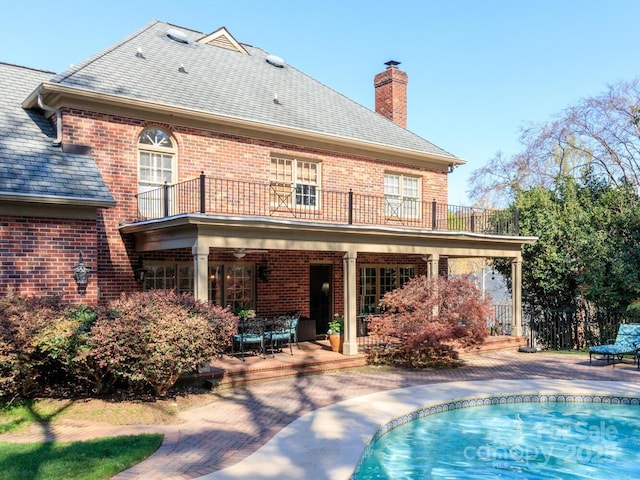 1233 Weymouth Ln, Charlotte, NC 28270 - rear view of property with a chimney, a patio area, brick siding, and a balcony