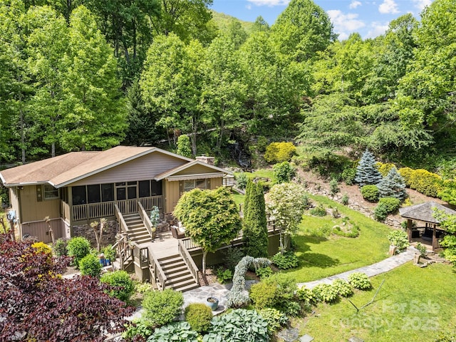 218 Red Oak Dr, Maggie Valley, NC 28751 - view of front of property with stairs, a sunroom, a front yard, a deck, and a wooded view