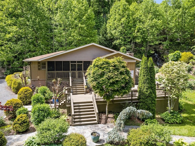 218 Red Oak Dr, Maggie Valley, NC 28751 - view of front of home with stairway, a sunroom, a deck, and a wooded view