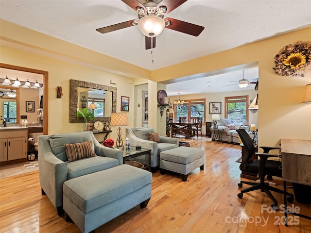 218 Red Oak Dr, Maggie Valley, NC 28751 - living area featuring ceiling fan, light wood finished floors, a chandelier, and a desk
