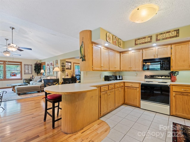 218 Red Oak Dr, Maggie Valley, NC 28751 - kitchen with black microwave, white electric range oven, a textured ceiling, a ceiling fan, and a peninsula