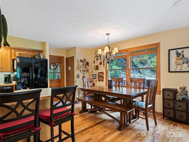 218 Red Oak Dr, Maggie Valley, NC 28751 - dining space featuring a chandelier, a textured ceiling, and light wood-type flooring