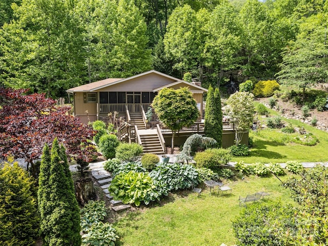 218 Red Oak Dr, Maggie Valley, NC 28751 - view of front facade featuring stairs, a sunroom, a deck, a front yard, and a wooded view