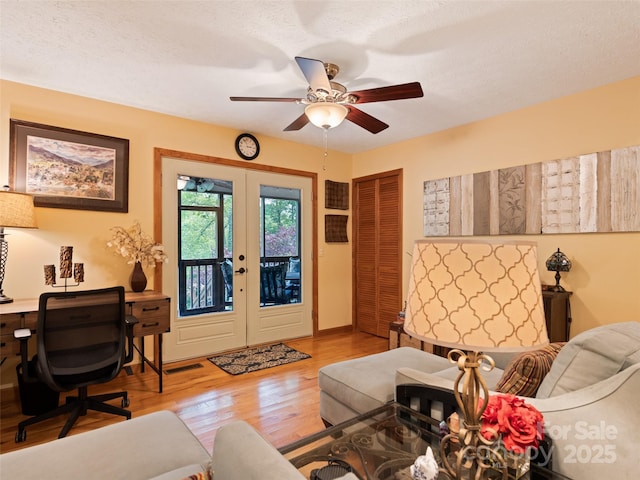 218 Red Oak Dr, Maggie Valley, NC 28751 - living room featuring french doors, a ceiling fan, wood finished floors, an office area, and baseboards