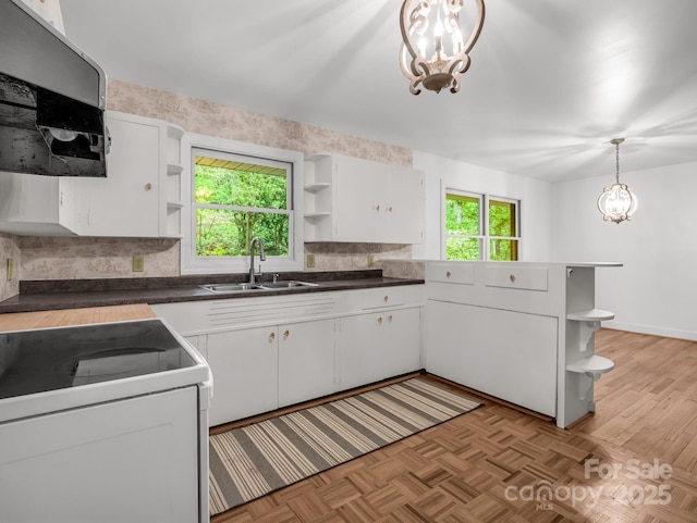 kitchen featuring open shelves, a sink, extractor fan, and a chandelier
