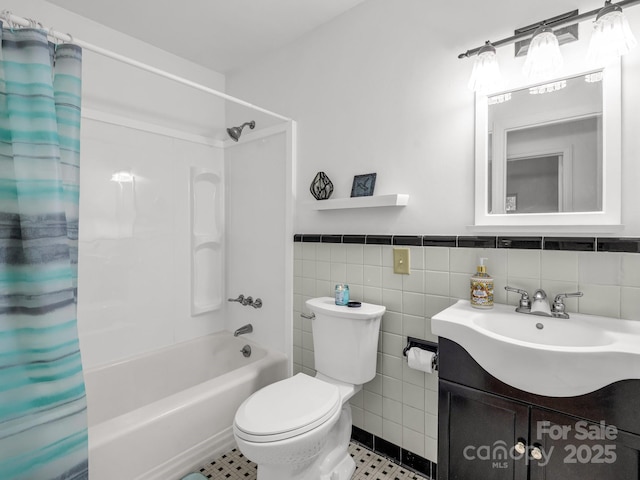 bathroom with shower / bath combo with shower curtain, toilet, tile walls, and vanity