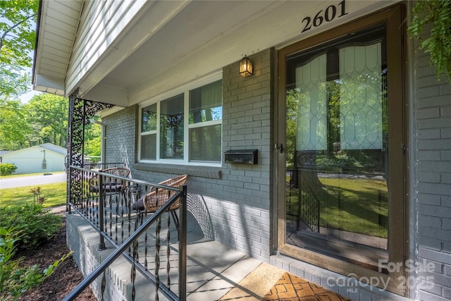 2601 Dora Dr, Charlotte, NC 28215 - view of exterior entry featuring brick siding and a porch