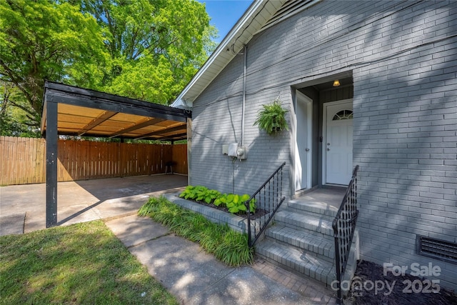 2601 Dora Dr, Charlotte, NC 28215 - property entrance with brick siding, driveway, and fence