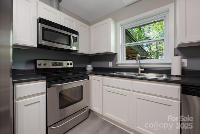 2601 Dora Dr, Charlotte, NC 28215 - kitchen featuring dark countertops, appliances with stainless steel finishes, and a sink