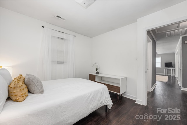 2601 Dora Dr, Charlotte, NC 28215 - bedroom with attic access, wood finished floors, visible vents, and baseboards