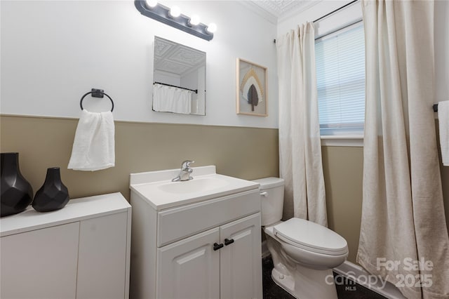 2601 Dora Dr, Charlotte, NC 28215 - bathroom featuring toilet, ornamental molding, and vanity