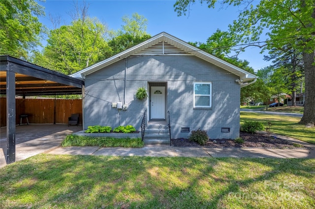 2601 Dora Dr, Charlotte, NC 28215 - bungalow with fence, brick siding, entry steps, crawl space, and a front yard