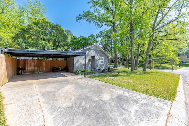 2601 Dora Dr, Charlotte, NC 28215 - view of car parking with fence, driveway, and a carport