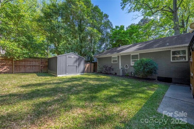 2601 Dora Dr, Charlotte, NC 28215 - view of yard featuring an outdoor structure, a shed, a fenced backyard, and central AC unit