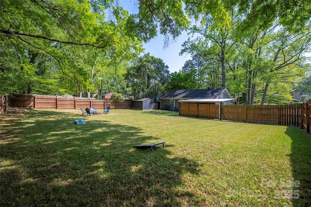2601 Dora Dr, Charlotte, NC 28215 - view of yard featuring a fenced backyard, a storage unit, and an outbuilding