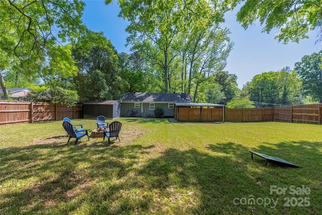 2601 Dora Dr, Charlotte, NC 28215 - view of yard featuring an outdoor fire pit, a fenced backyard, an outbuilding, and a shed